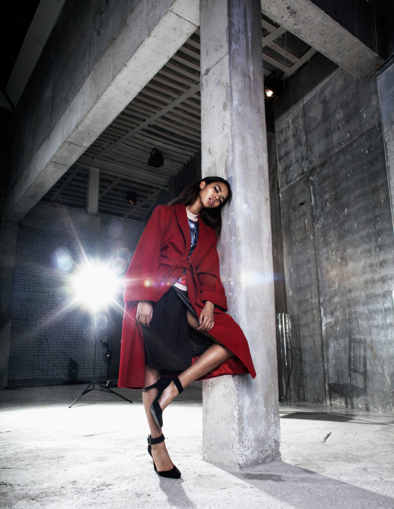 stylish-woman-in-red-coat-posing-in-studio-2026-03-26-06-05-57-utc