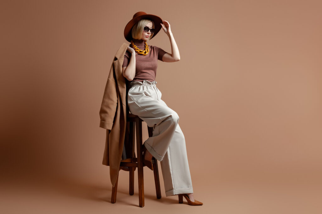 stylish-woman-in-wide-leg-pants-sitting-on-stool-2026-01-08-06-01-33-utc
